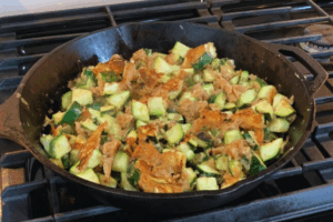 Fried Zucchini cooking in a cast iron skillet