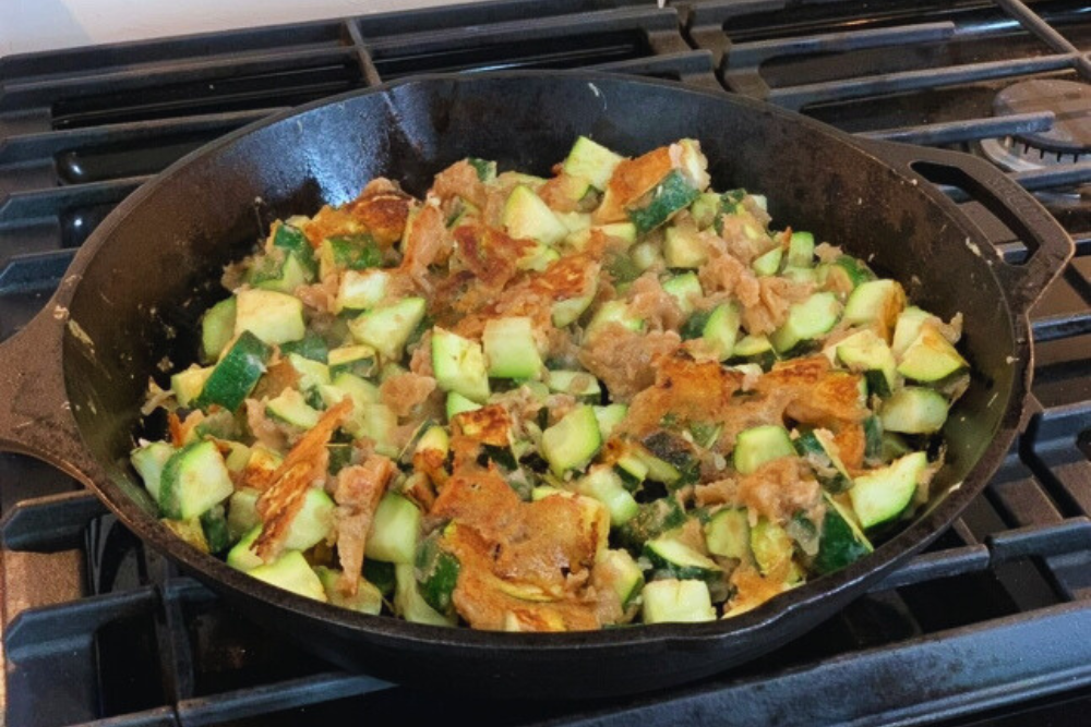 Fried Zucchini cooking in a cast iron skillet