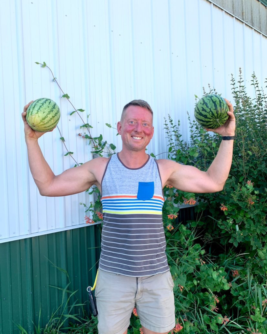 Scott Rosenberg smiling and holding two small watermelons, one in each hand