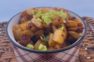 Russet Home Fries in small plaid-print bowl topped with green onion garnish
