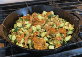 Fried Zucchini cooking in a cast iron skillet