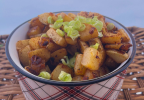 Russet Home Fries in small plaid-print bowl topped with green onion garnish